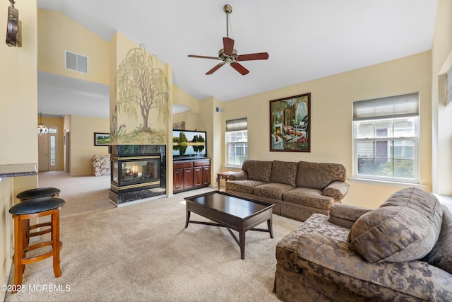 6 Boticelli Ct, Manchester, NJ 08759 - living area with high vaulted ceiling, light colored carpet, a multi sided fireplace, ceiling fan, and a chandelier