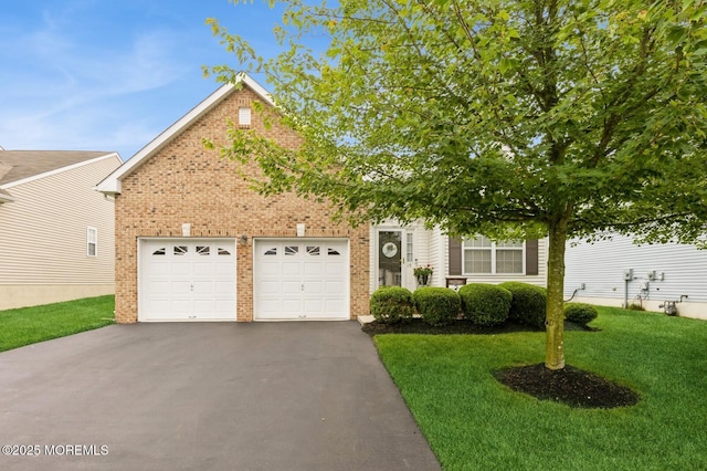 10 Inkberry Ln, Howell, NJ 07731 - obstructed view of property featuring driveway, a front yard, a garage, and brick siding