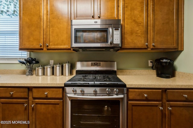 10 Inkberry Ln, Howell, NJ 07731 - kitchen with appliances with stainless steel finishes, light countertops, and brown cabinetry