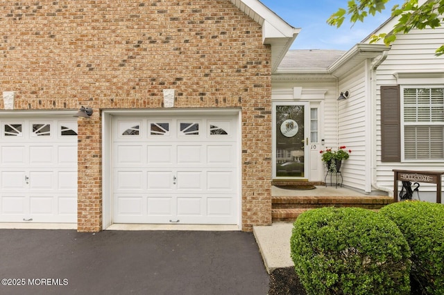 10 Inkberry Ln, Howell, NJ 07731 - view of exterior entry featuring driveway, a garage, and brick siding