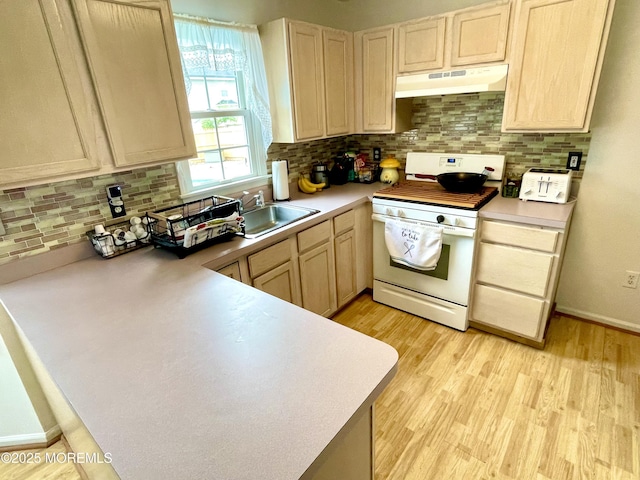 229 Stern Ave, Manahawkin, NJ 08050 - kitchen with under cabinet range hood, white range oven, light wood-style floors, and backsplash