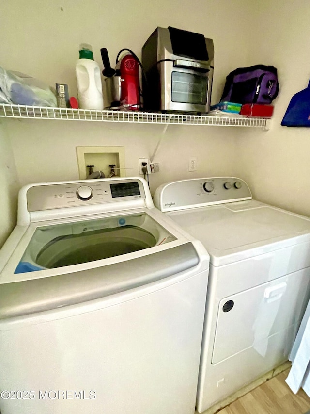 229 Stern Ave, Manahawkin, NJ 08050 - laundry area with washer and clothes dryer and wood finished floors