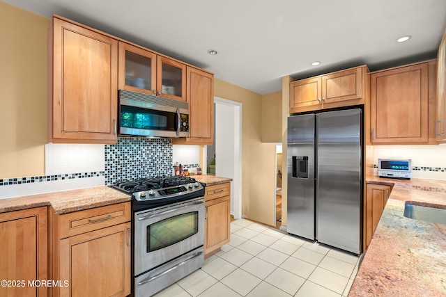 4 Hamilton Hill Rd, Lincroft, NJ 07738 - kitchen featuring stainless steel appliances, decorative backsplash, glass insert cabinets, light tile patterned floors, and light stone counters