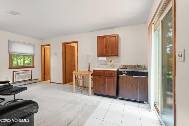 4 Hamilton Hill Rd, Lincroft, NJ 07738 - kitchen featuring a wall mounted AC, brown cabinets, light tile patterned floors, baseboard heating, and light countertops