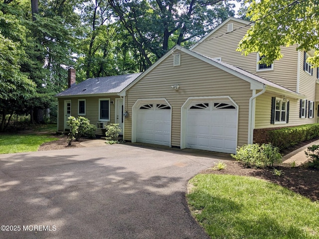 4 Hamilton Hill Rd, Lincroft, NJ 07738 - view of front of house with an attached garage, asphalt driveway, and a chimney