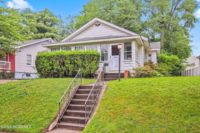 16 Steiner Ave, Neptune City, NJ 07753 - view of front of property with a front lawn, entry steps, and roof with shingles