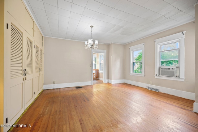 16 Steiner Ave, Neptune City, NJ 07753 - unfurnished dining area with wood-type flooring, a chandelier, cooling unit, and ornamental molding