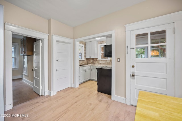 16 Steiner Ave, Neptune City, NJ 07753 - kitchen with light wood-style floors, backsplash, light countertops, and white cabinetry