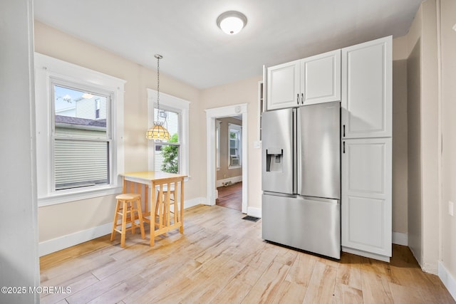 16 Steiner Ave, Neptune City, NJ 07753 - kitchen with stainless steel fridge with ice dispenser, light wood-style floors, white cabinets, and pendant lighting