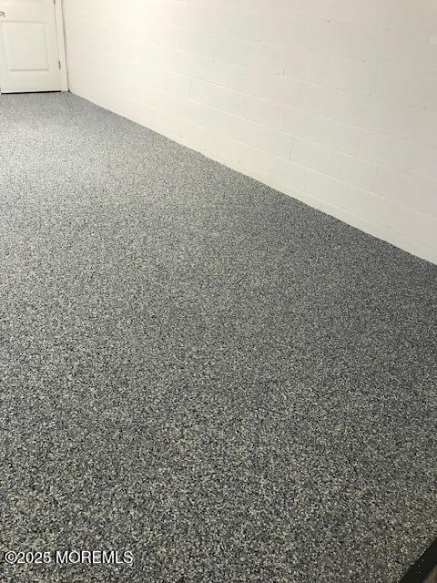 119 Dupont Ave Unit 2A, Seaside Heights, NJ 08751 - detailed view of speckle patterned floor and concrete block wall