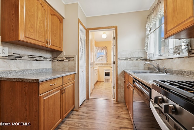 413 Sullivan Pl, Union Beach, NJ 07735 - kitchen with stainless steel dishwasher, range, light wood-type flooring, ornamental molding, and brown cabinetry
