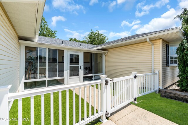 13 Canaries Ct, Toms River, NJ 08757 - view of home's exterior featuring roof with shingles, a sunroom, and a lawn