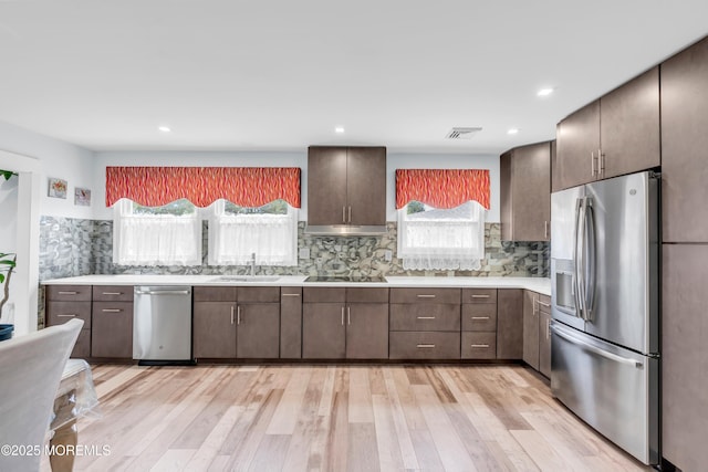 13 Canaries Ct, Toms River, NJ 08757 - kitchen featuring stainless steel appliances, light countertops, light wood finished floors, tasteful backsplash, and dark brown cabinetry