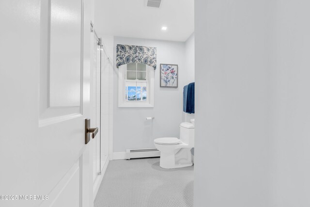 13 Canaries Ct, Toms River, NJ 08757 - bathroom with baseboard heating, a shower with shower door, and tile patterned flooring