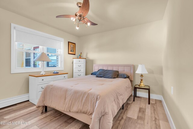 13 Canaries Ct, Toms River, NJ 08757 - bedroom with a baseboard radiator, light wood-style floors, and a ceiling fan