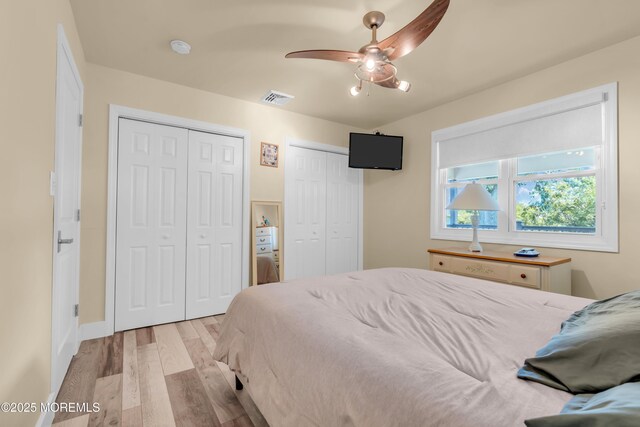 13 Canaries Ct, Toms River, NJ 08757 - bedroom with multiple closets, light wood-type flooring, and a ceiling fan