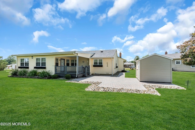 13 Canaries Ct, Toms River, NJ 08757 - back of property featuring a lawn, a patio, and an outdoor structure