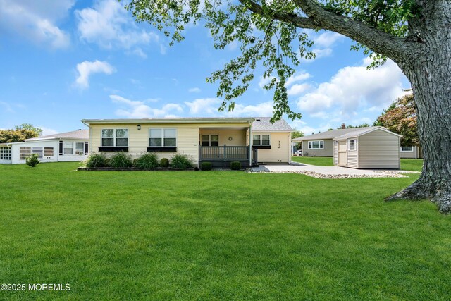 13 Canaries Ct, Toms River, NJ 08757 - back of property featuring a lawn and a patio