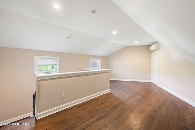 7 Rodeo Ct, Howell, NJ 07731 - additional living space with vaulted ceiling, dark wood-style floors, a wall mounted AC, and recessed lighting