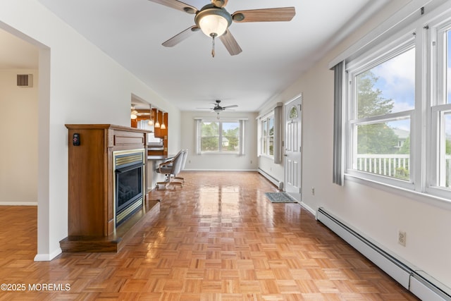 3 Shaw Ct, Toms River, NJ 08757 - unfurnished living room featuring baseboard heating, a ceiling fan, and a fireplace