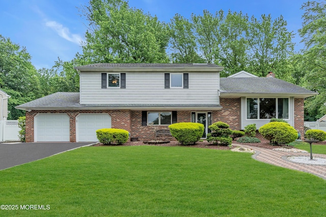 25 Canadian Woods Rd, Marlboro, NJ 07746 - tri-level home with driveway, brick siding, and a garage