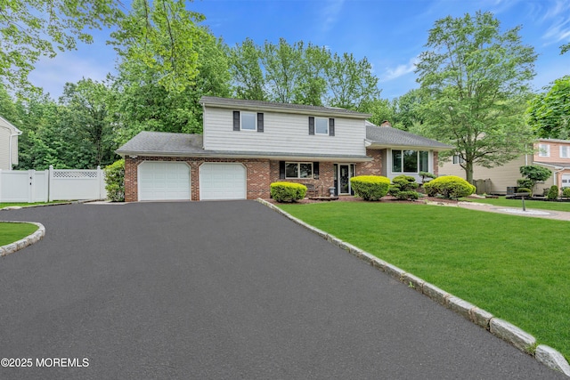 25 Canadian Woods Rd, Marlboro, NJ 07746 - tri-level home featuring brick siding, asphalt driveway, an attached garage, and a chimney