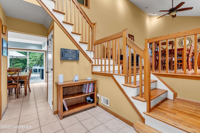 25 Canadian Woods Rd, Marlboro, NJ 07746 - stairway featuring ceiling fan, tile patterned floors, and vaulted ceiling