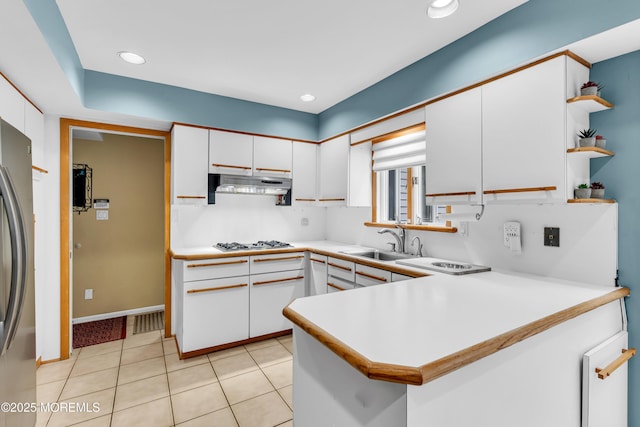 25 Canadian Woods Rd, Marlboro, NJ 07746 - kitchen featuring under cabinet range hood, white cabinets, light countertops, a peninsula, and freestanding refrigerator