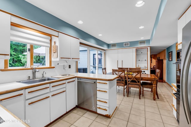 25 Canadian Woods Rd, Marlboro, NJ 07746 - kitchen featuring stainless steel dishwasher, white cabinets, a peninsula, light countertops, and recessed lighting