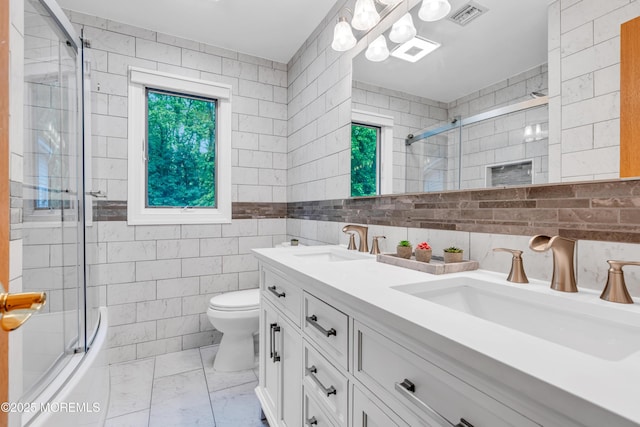 25 Canadian Woods Rd, Marlboro, NJ 07746 - bathroom featuring marble finish flooring, double vanity, tile walls, and enclosed tub / shower combo