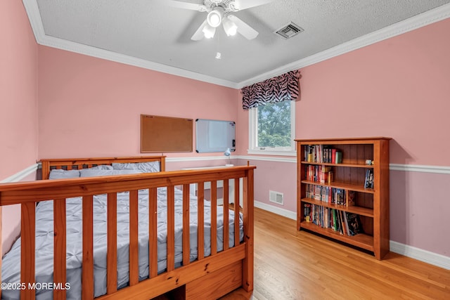25 Canadian Woods Rd, Marlboro, NJ 07746 - bedroom with wood finished floors, crown molding, and a textured ceiling