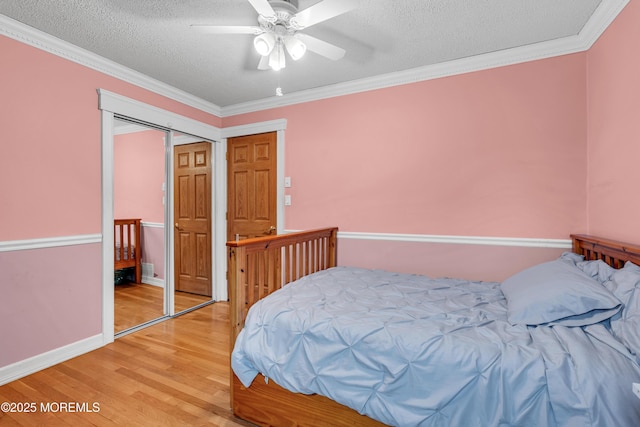 25 Canadian Woods Rd, Marlboro, NJ 07746 - bedroom featuring light wood-style floors, a textured ceiling, ornamental molding, and a ceiling fan