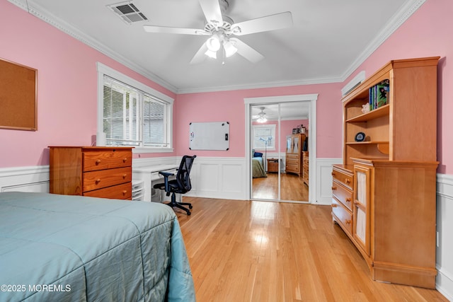25 Canadian Woods Rd, Marlboro, NJ 07746 - bedroom featuring crown molding, light wood-style flooring, wainscoting, a ceiling fan, and a desk