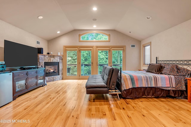 25 Canadian Woods Rd, Marlboro, NJ 07746 - bedroom with hardwood / wood-style floors, access to exterior, lofted ceiling, a glass covered fireplace, and refrigerator