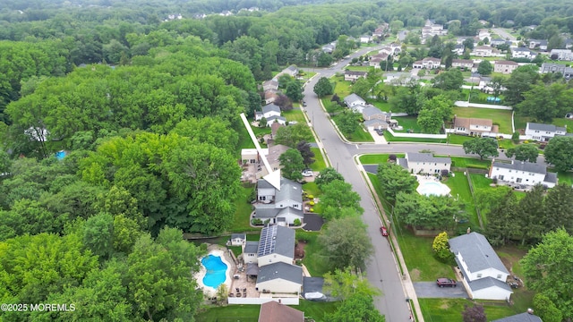 25 Canadian Woods Rd, Marlboro, NJ 07746 - aerial perspective of suburban area featuring a pool and a forest