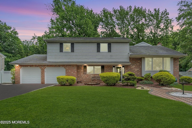 25 Canadian Woods Rd, Marlboro, NJ 07746 - view of front facade with driveway, an attached garage, and brick siding