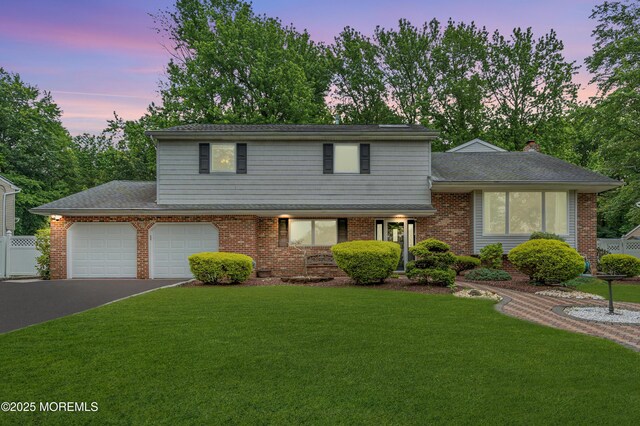 25 Canadian Woods Rd, Marlboro, NJ 07746 - view of front facade with driveway, an attached garage, and brick siding