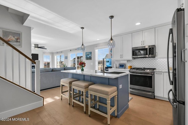 917 Jane Dr, Beach Haven West, NJ 08050 - kitchen with stainless steel appliances, white cabinetry, light wood finished floors, recessed lighting, and crown molding
