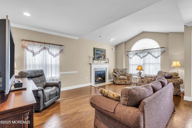 42 Eagleswood Dr, Waretown, NJ 08758 - living room featuring healthy amount of natural light, a glass covered fireplace, lofted ceiling, wood finished floors, and ornamental molding