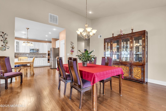 42 Eagleswood Dr, Waretown, NJ 08758 - dining room with a chandelier, wood finished floors, a high ceiling, and recessed lighting