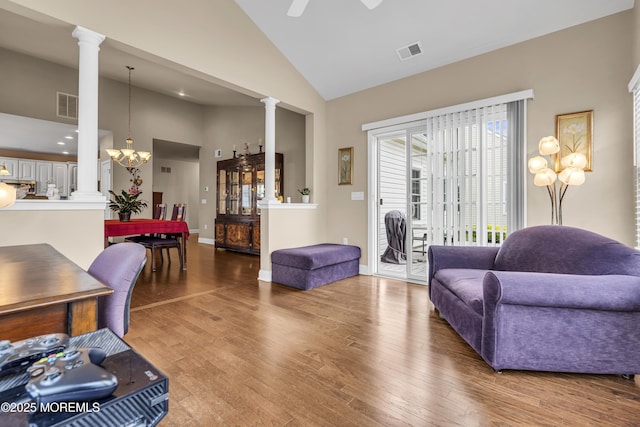 42 Eagleswood Dr, Waretown, NJ 08758 - living room with decorative columns, high vaulted ceiling, wood finished floors, a ceiling fan, and a chandelier
