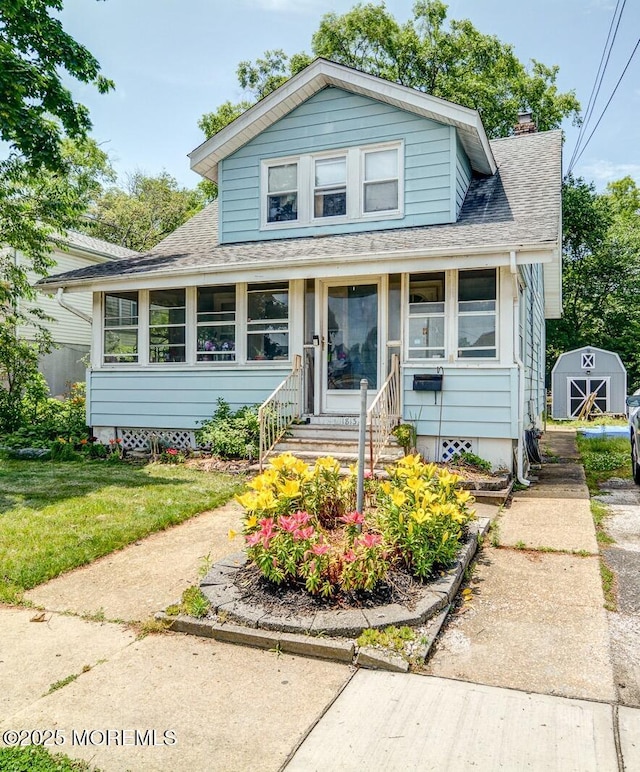 1813 Margerum Ave, Belmar, NJ 07719 - bungalow-style house with a shingled roof, a storage unit, a chimney, a front lawn, and entry steps
