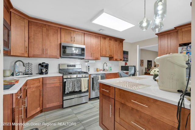 1D Daisy Ct, Lakewood, NJ 08701 - kitchen with stainless steel appliances and brown cabinetry