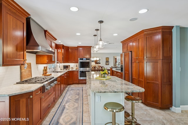 4040 Herbertsville Rd, Wall, NJ 08724 - kitchen with stainless steel appliances, wall chimney exhaust hood, recessed lighting, a kitchen island, and light stone counters