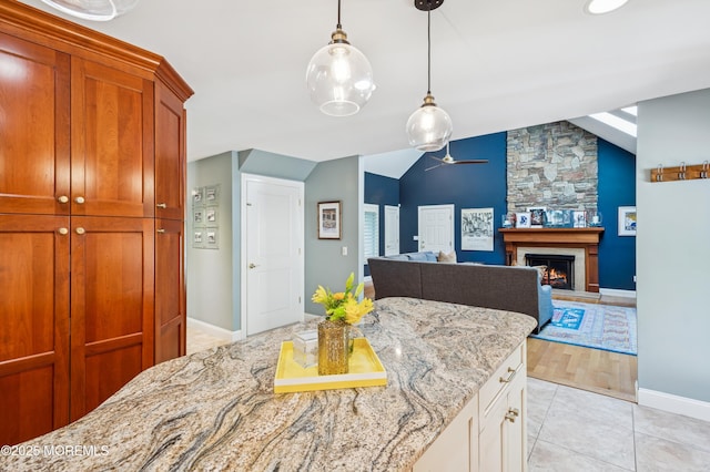 4040 Herbertsville Rd, Wall, NJ 08724 - kitchen with ceiling fan, a fireplace, decorative light fixtures, light stone counters, and lofted ceiling