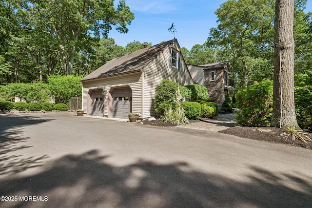 4040 Herbertsville Rd, Wall, NJ 08724 - view of side of property featuring driveway and an attached garage