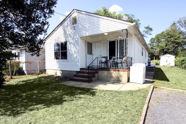 19 E 4th St, Howell, NJ 07731 - view of front of house featuring a storage shed and covered porch