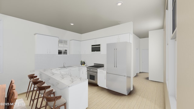 1300 Ocean Ter, Seaside Heights, NJ 08751 - kitchen with high quality appliances, tasteful backsplash, a breakfast bar, white cabinetry, and recessed lighting