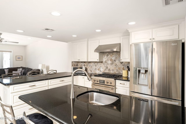 3 Newark Ave, Lavallette, NJ 08735 - kitchen featuring stainless steel appliances, dark countertops, wall chimney range hood, decorative backsplash, and a peninsula