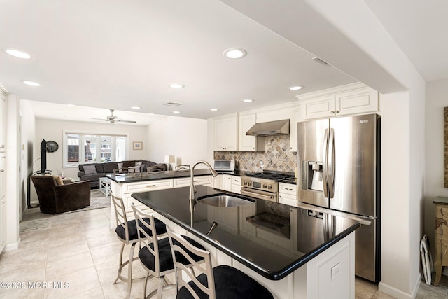 3 Newark Ave, Lavallette, NJ 08735 - kitchen featuring stainless steel appliances, wall chimney exhaust hood, dark countertops, a peninsula, and backsplash